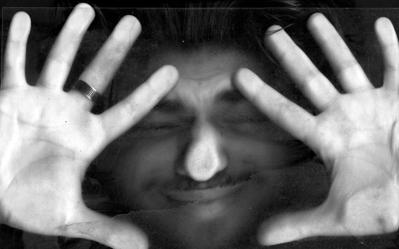 Face and hands pressed against glass